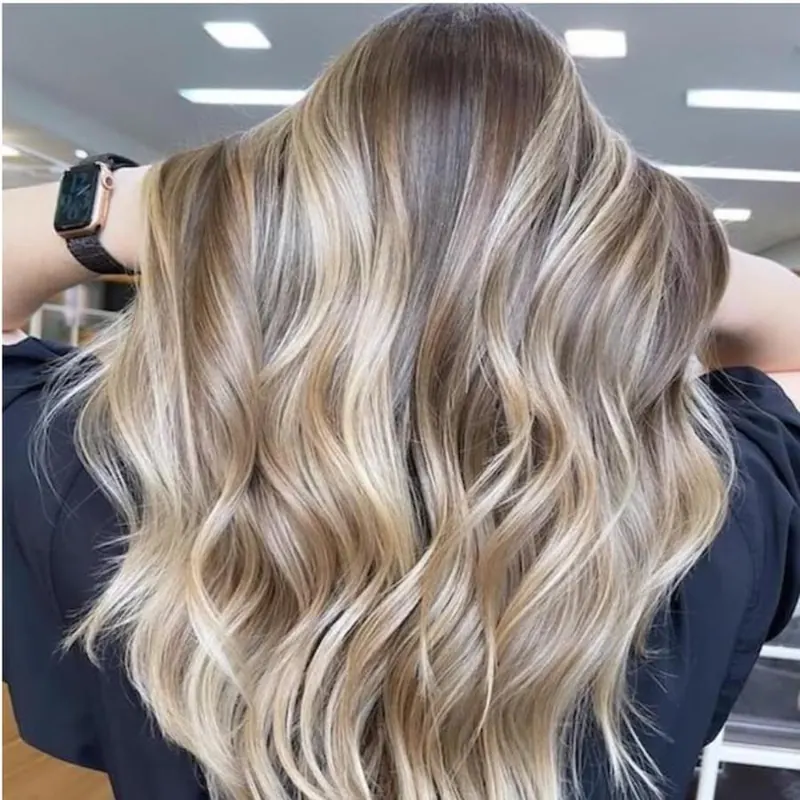 Long hair with soft blonde balayage waves, finished at Palm Beach Hair Co.