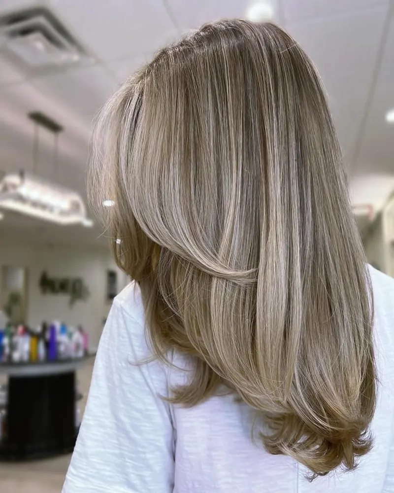 Long layered hair with a smooth, sleek finish at Palm Beach Hair Co.