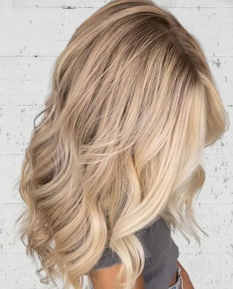 Long blonde hair in soft waves, back view, at Palm Beach Hair Co.