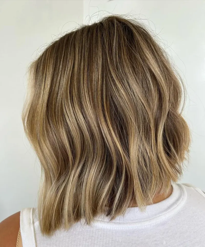 A short blonde bob with soft waves at Palm Beach Hair Co.