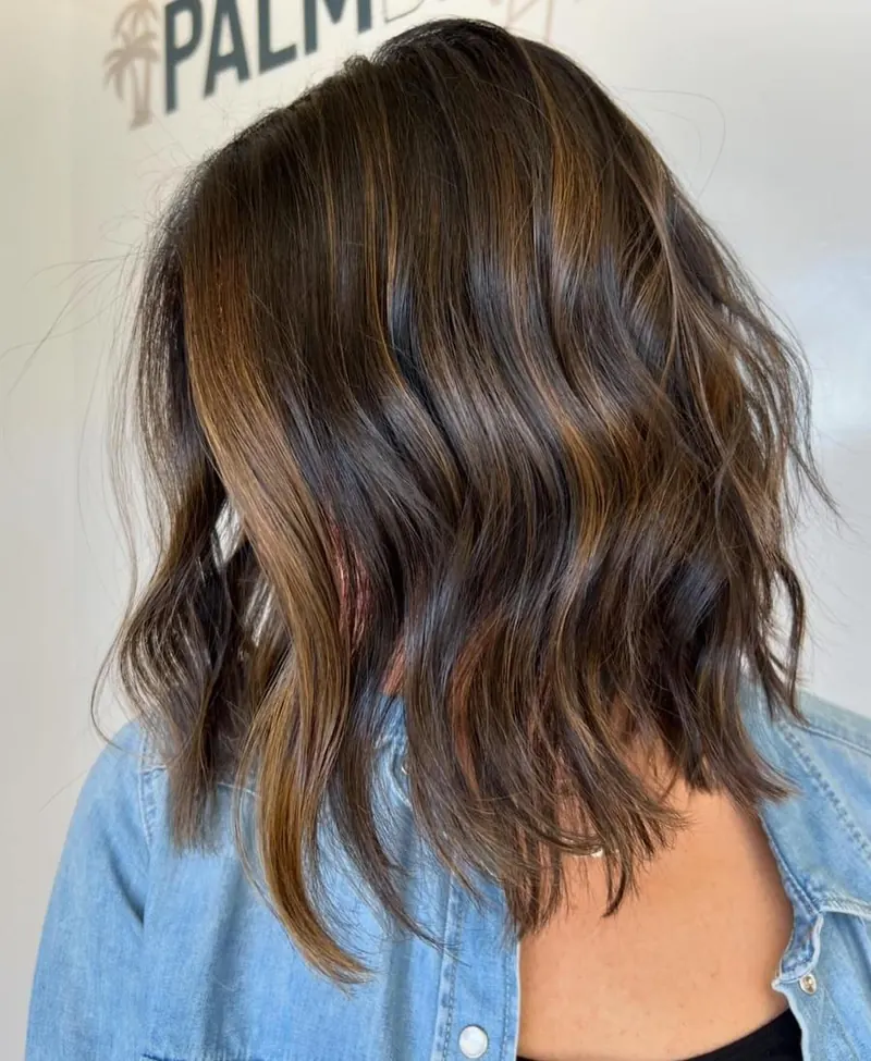 A brunette bob with lived in waves at Palm Beach Hair Co.