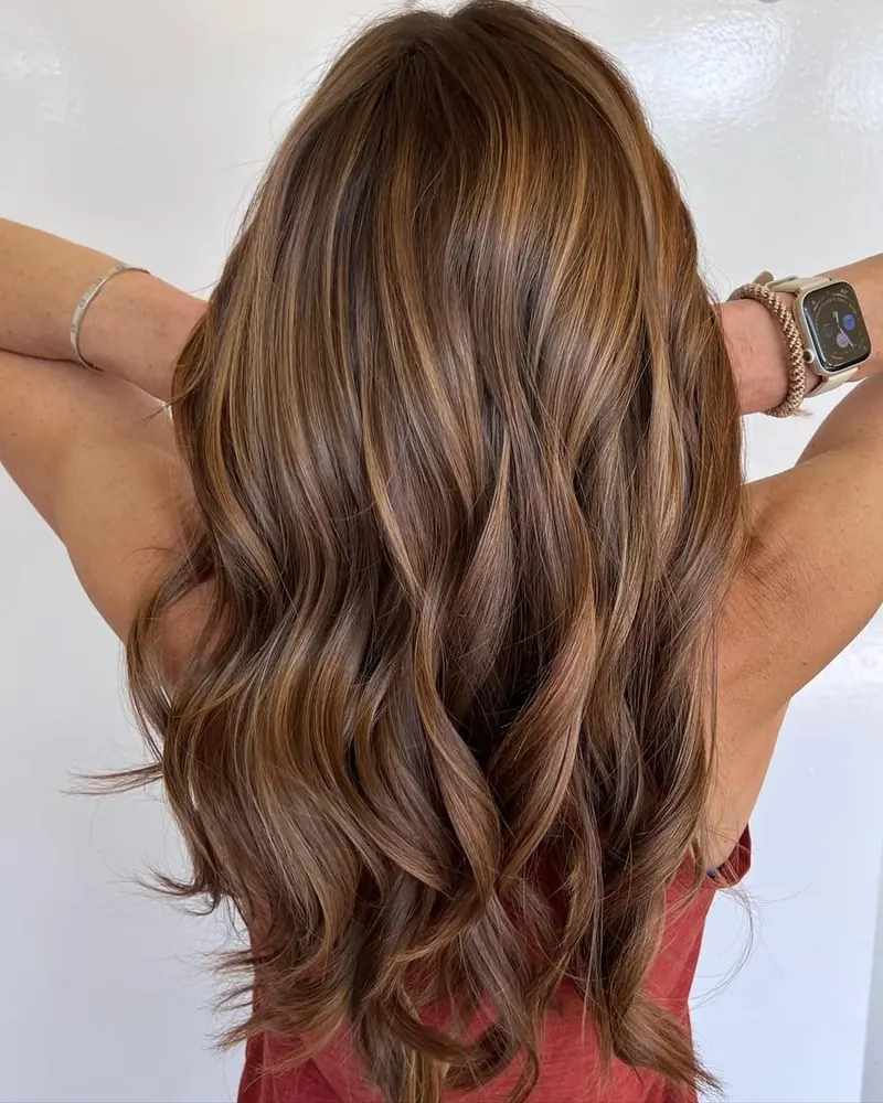 Long brunette hair with warm waves at Palm Beach Hair Co.