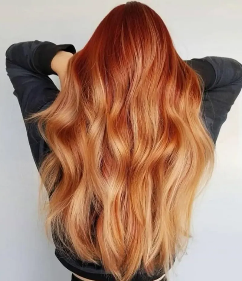 Long copper hair in glossy waves, back view, at Palm Beach Hair Co.