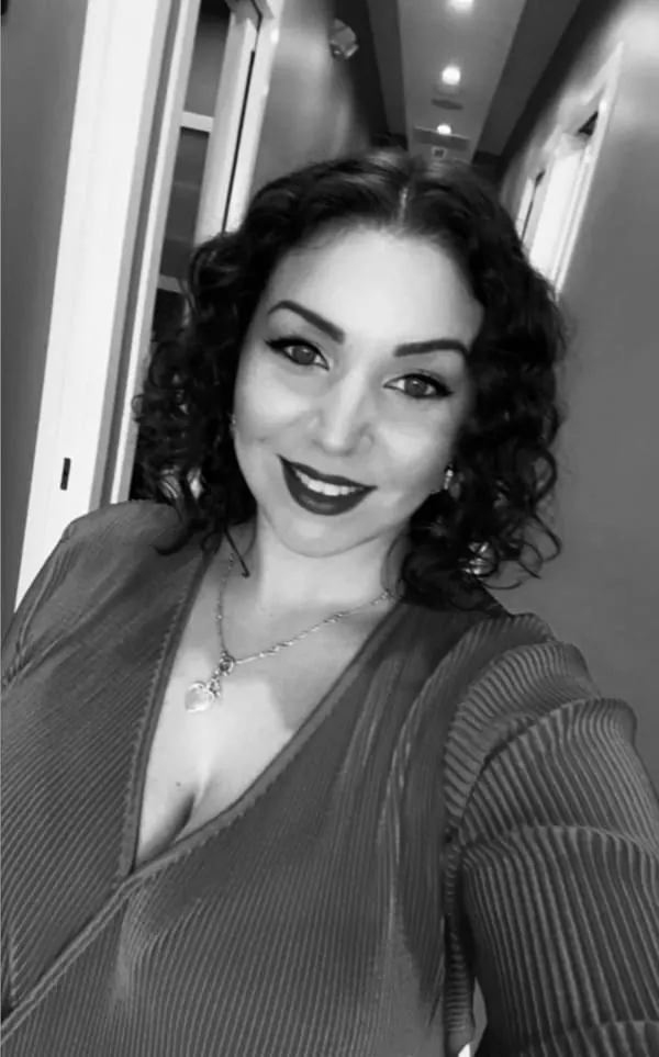 A guest with finished makeup and styled dark hair at Palm Beach Hair Co.