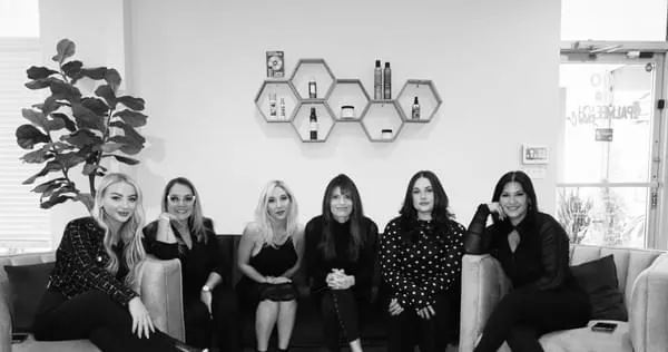 The Palm Beach Hair Co. team seated together in the salon